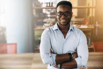 Portrait of an attractive african american guy in formal shirt at office - Powered by Adobe