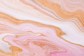 Fluid art texture. Backdrop with abstract iridescent paint effect. Liquid acrylic picture that flows and splashes. Mixed paints for background or poster. Golden, pink and white overflowing colors