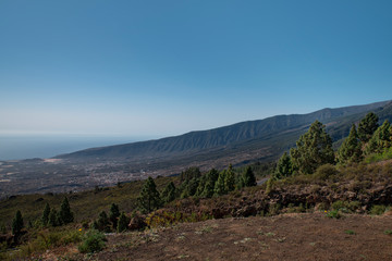 Fototapeta premium View of the green slopes of Guimar valley, situated on the east coast of the island, as seen from a viewpoint known as Mirador de Chivisaya, on Carretera Los Loros, in Tenerife, Canary Islands, Spain