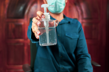 alcohol hand sanitizer bottle in man hand. Concepts of Flu virus, Coronavirus disease or Covid-19. Can used for microbiology concept or medical healthcare.