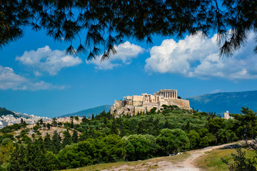 Fototapeta premium Famous greek tourist landmark - the iconic Parthenon Temple at the Acropolis of Athens as seen from Philopappos Hill, Athens, Greece