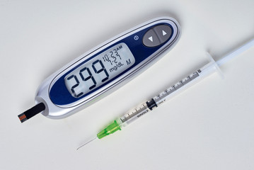diabetes, glucometer with glucose measurement on screen and blood on test strip