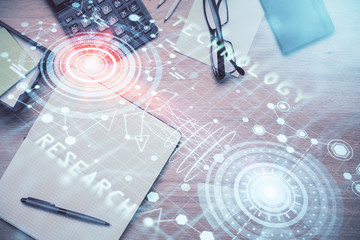 Double exposure of technology theme drawing over work table desktop. Top view. Global data analysis concept.