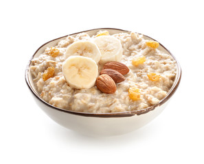 Bowl with tasty sweet oatmeal on white background