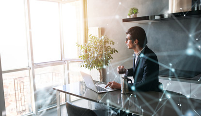 Businessman works from remote at house with a laptop due to coronavirus quarantine.