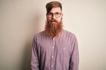 Handsome Irish redhead business man with beard wearing glasses over isolated background depressed and worry for distress, crying angry and afraid. Sad expression.