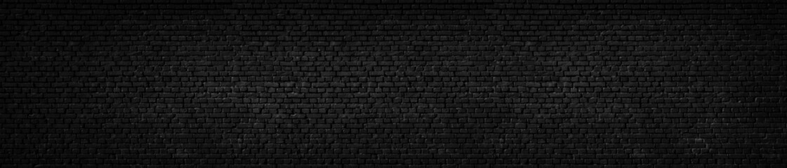 Texture of a black painted brick wall as a background or wallpaper