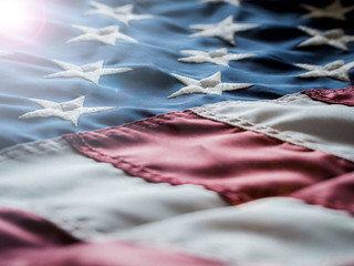American flag or United States of America flag waving in the wind with blue sky and is a symbol of...