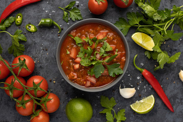 Traditional Latin American mexican salsa sauce and ingredients on stone table. Top view. Tomatoo sauce