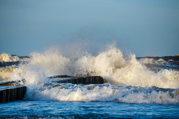 Autumn sea storm with splash from big waves over pier from the baltic coast