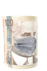 COVID-19 coronavirus in Canada, 100 dollar money bill with face mask. COVID affects global stock market.