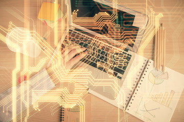 Double exposure of man's hands typing over computer keyboard and tech theme hologram drawing. Top view. Technology concept.