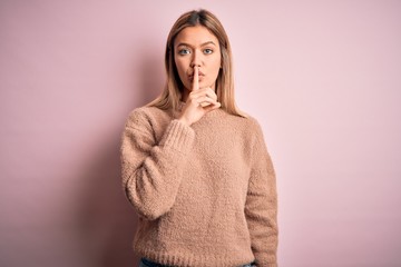 Young beautiful blonde woman wearing winter wool sweater over pink isolated background asking to be...