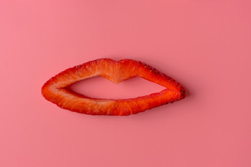 Contemporary art. Concept strawberry lips on pink background. Food art