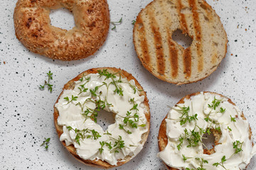 A bagel with cream cheese and microgreen