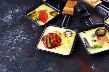 Delicious traditional Swiss melted raclette cheese on diced boiled or baked potato.