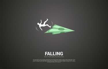silhouette of businessman slip and falling down from money banknote origami paper airplane. Concept for fail and accidental business
