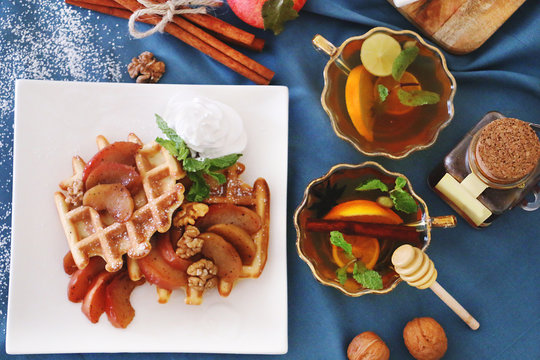 waffles sered with walnuts, honey and baked aples