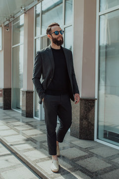 Handsome Man With Beard In Trendy Formal Suit. Guy With Beard Wearing Black Long Sleeve T-shirt Or Sweater With Space For Your Brand Name Or Label. Mockup For Print