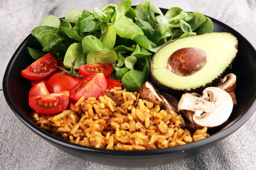 Healthy vegan salad bowl with quinoa, tomatoes, avocado and mixed greens, lettuce. Food and health bowl