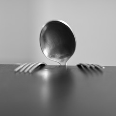spoon and forks behind the table 