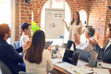 Group of business workers working together in a meeting. One of them making presentation to...
