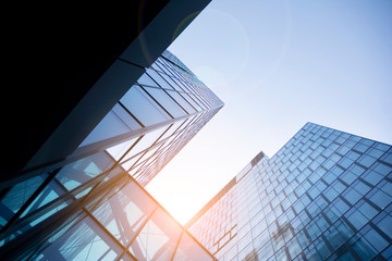 Skyscraper, modern building in the city with sunlight. Glass wall of an office building in the...