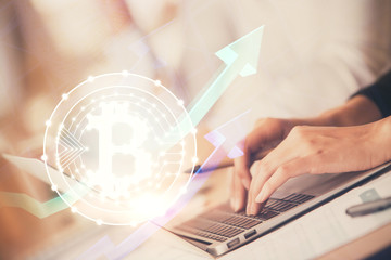 Double exposure of woman hands typing on computer and crypto market theme hologram drawing. Blockchain concept.