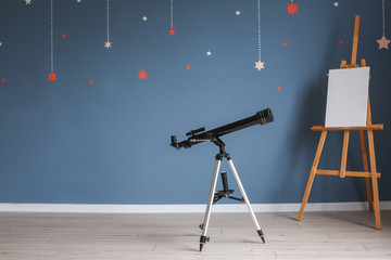 Modern telescope in interior of room