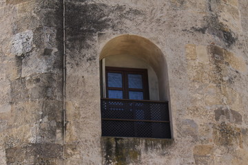 A window of Tower of Gold (Torre del Oro) military watchtower, built in 13th century by Almohad Caliphate on the bank of Guadalquivir river in Seville, Andalusia, Spain.