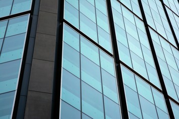 Abstract reflection of modern city glass facades. Modern office building detail, glass surface.