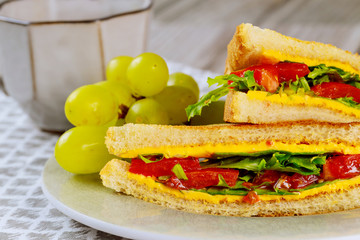 Grilled cheese sandwich with vegetable and grape.