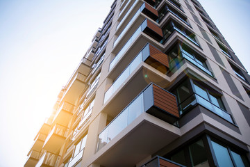 Apartment residential house and home facade architecture and outdoor facilities. Blue sky on the background. Sunlight