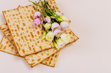 Jewish matzah bread with flowers on white background. Passover holiday concept