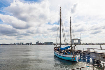 Fototapeta na wymiar Sail boat docked in Amsterdam