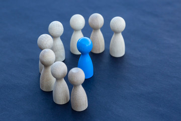 Obraz premium Personal development. Wooden figure in a crowd. Think different.
