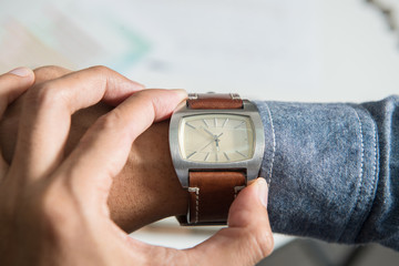 Fototapeta premium businessman looking at his watch on his hand