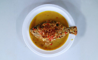 Pecak mujair or Mozambique tilapia on white background. Spicy Indonesian cuisine.