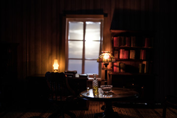 A realistic dollhouse living room with furniture and window at night. Artwork table decoration with...