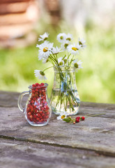 Charming still life with copy space strawberries and daisies