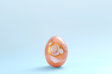 Easter minimal composition with single golden decorated egg on blue background. Copy space, front view. Greeting card. Macro photography