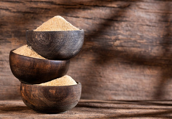 Organic maca root powder in wooden bowls - Lepidium meyenii