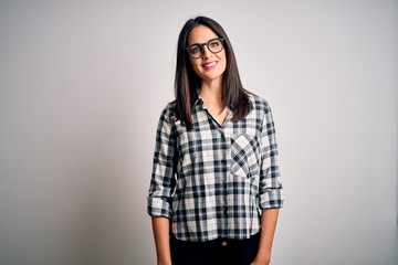 Young brunette woman with blue eyes wearing casual shirt and glasses over white background with a happy and cool smile on face. Lucky person.