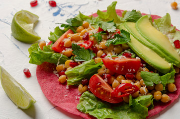Vegan beetroot taco with salad, avocado, chickpea and vegetables
