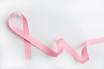 Obraz na płótnie Canvas Pink colored ribbon isolated on white. Symbol of breast cancer awareness. healthcare and medicine concept. Preventive measures. Women health