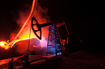 Oil pump and oil refining factory at night with fog and backlight. Energy industrial concept....
