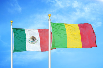 Mexico and Mali two flags on flagpoles and blue cloudy sky
