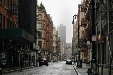 Empty New York City streets without people and closed shops during pandemic coronavirus outbreak in...