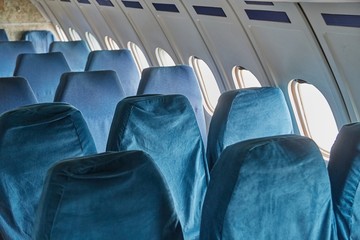 Empty rows of seats on an old plane