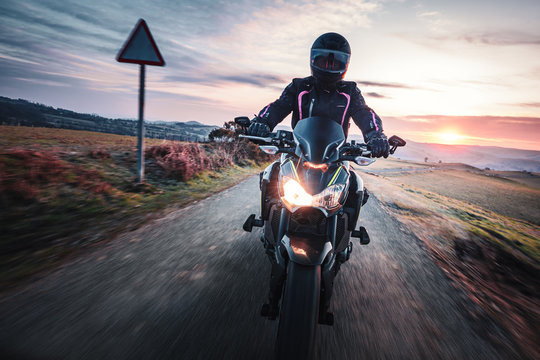 Motorcycle Ride Across Scenic Countryside At Sunrise